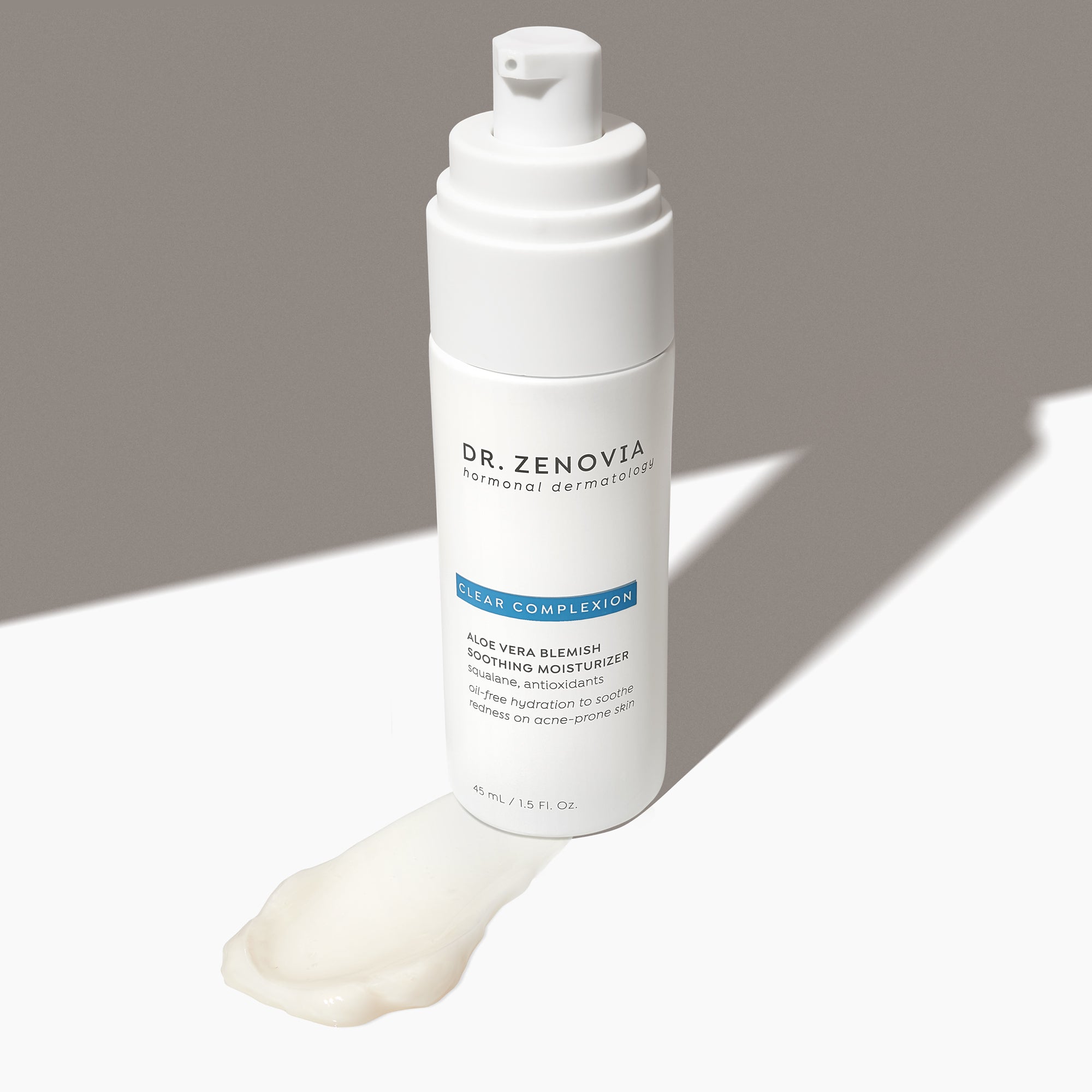 Angled view of Dr. Zenovia Aloe Vera Blemish Soothing Moisturizer bottle with pump and a smear of its gel-cream formula
