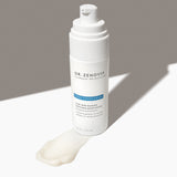 Angled view of Dr. Zenovia Aloe Vera Blemish Soothing Moisturizer bottle with pump and a smear of its gel-cream formula