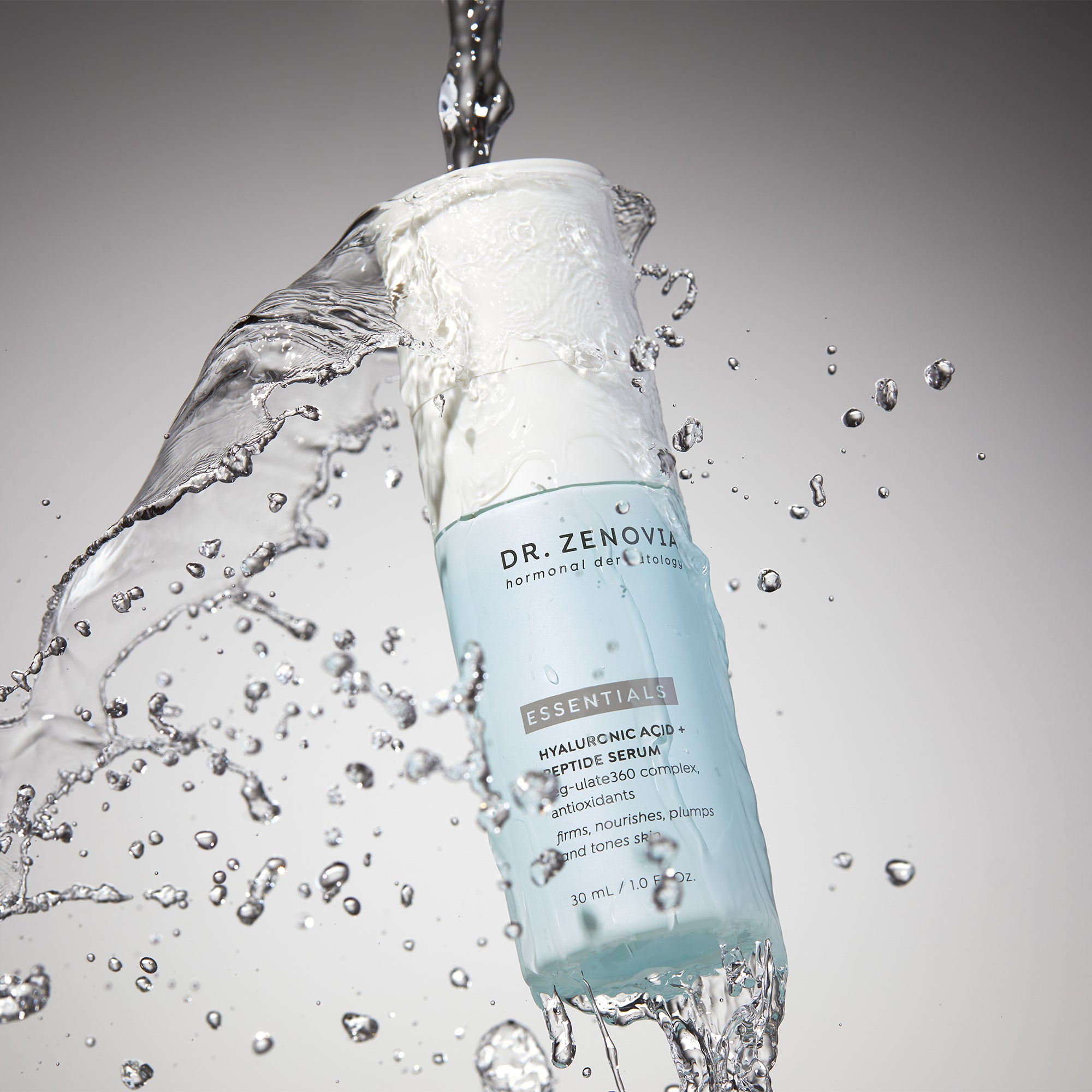 Dr. Zenovia Hyaluronic Acid + Peptide Serum bottle in motion with water splash, highlighting hydration benefits